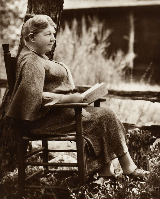 Sepia, 8×10, 1934. Seated holding a book. Photographer: Bachrach.